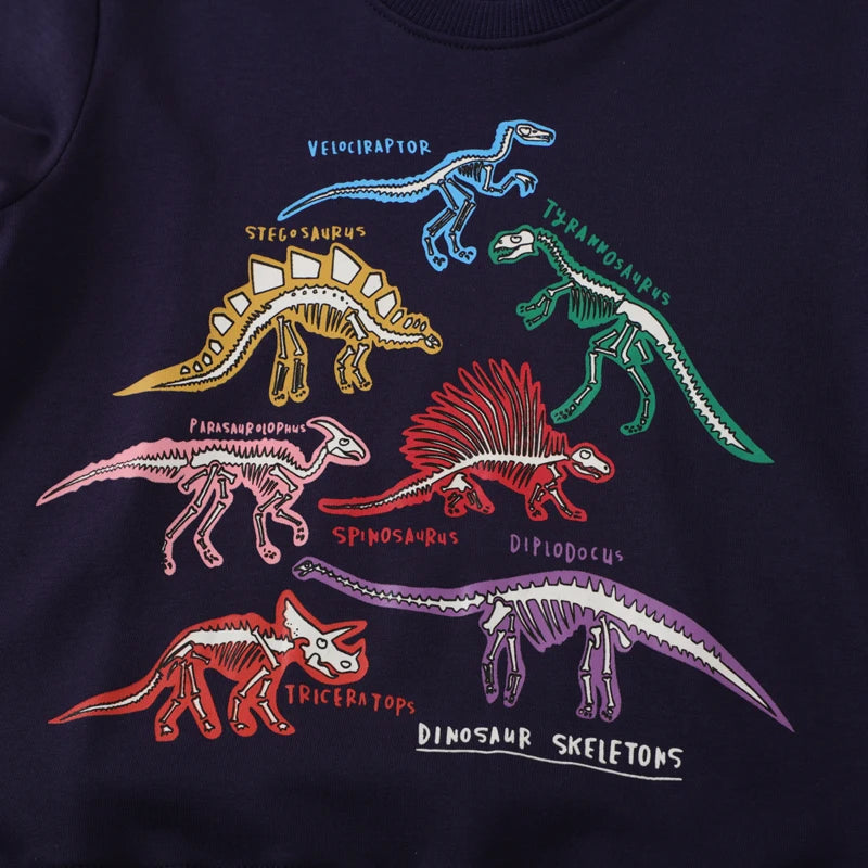 Close-up of the Go Glow dinosaur design featuring glowing dinosaur skeleton illustrations in various colors on a dark background.