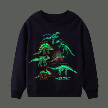 Go Glow dinosaur sweater featuring glowing dinosaur skeleton illustrations on a dark background.