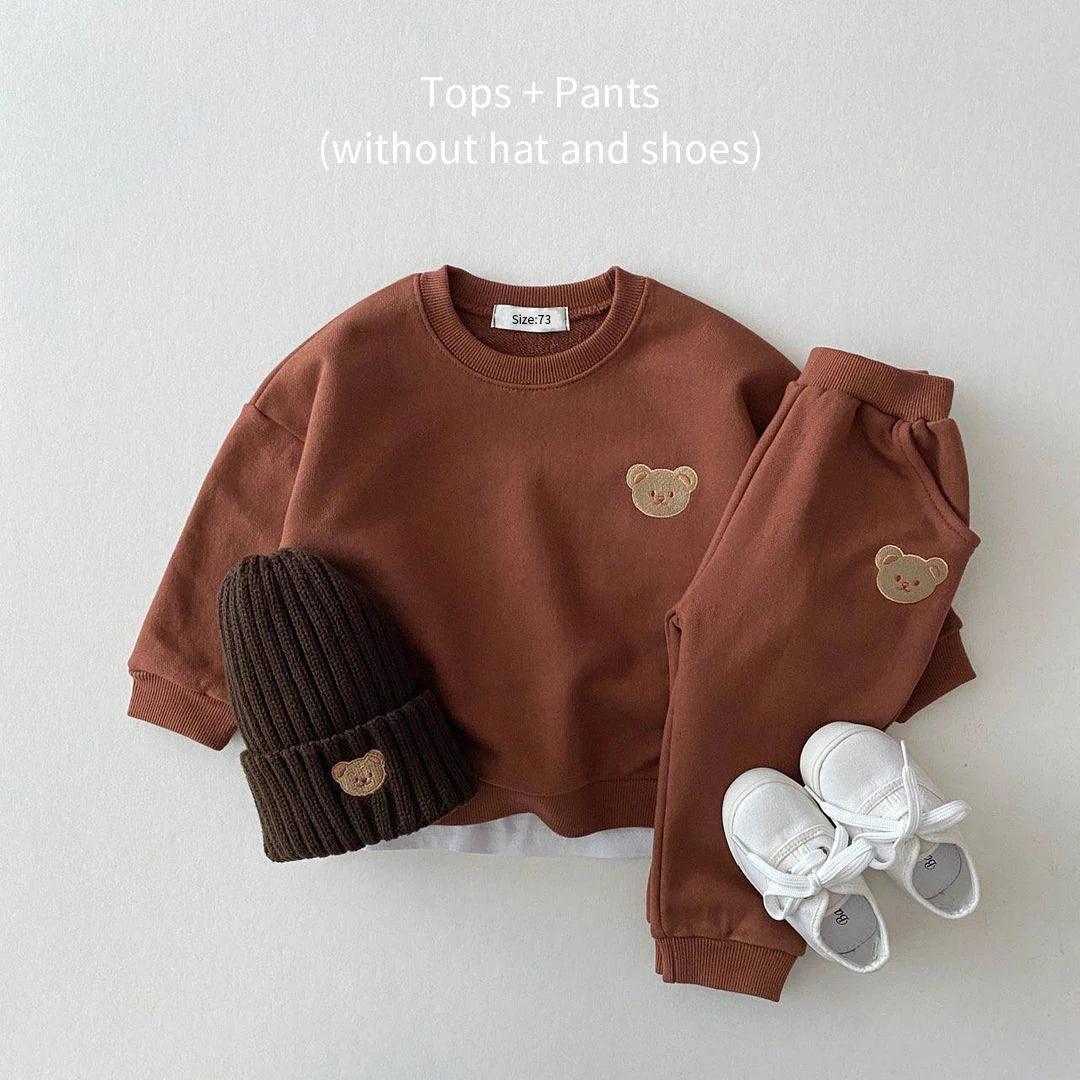 Soft and cozy brown baby outfit set featuring a sweatshirt and matching pants with adorable embroidered bear face details