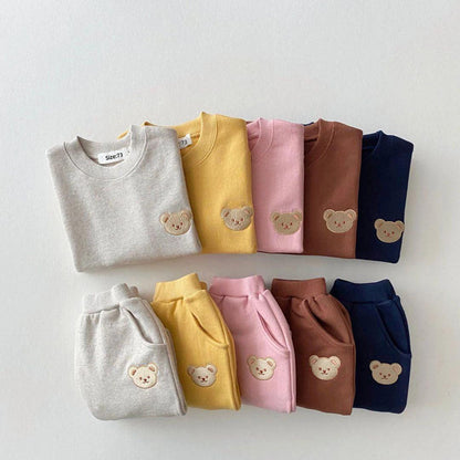 Soft and cozy baby outfit set featuring a sweatshirt and matching pants with adorable embroidered bear face details