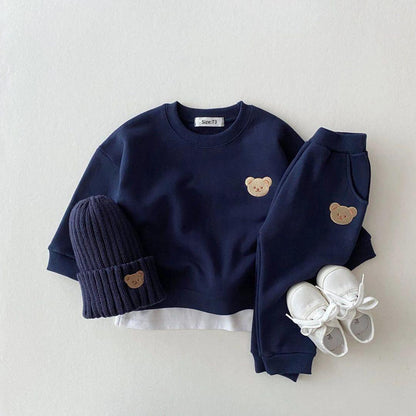 Soft and cozy dark blue baby outfit set featuring a sweatshirt and matching pants with adorable embroidered bear face details