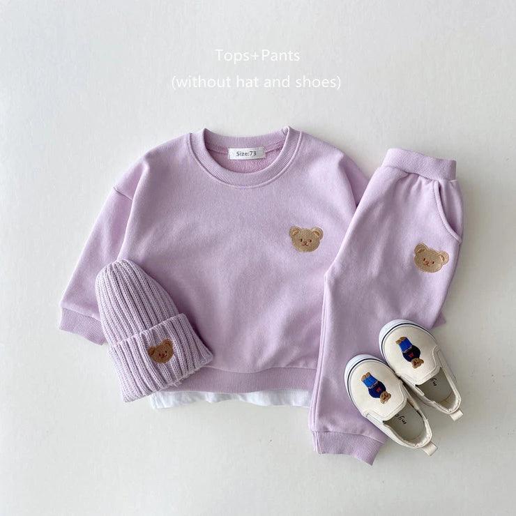 Soft and cozy purple baby outfit set featuring a sweatshirt and matching pants with adorable embroidered bear face details