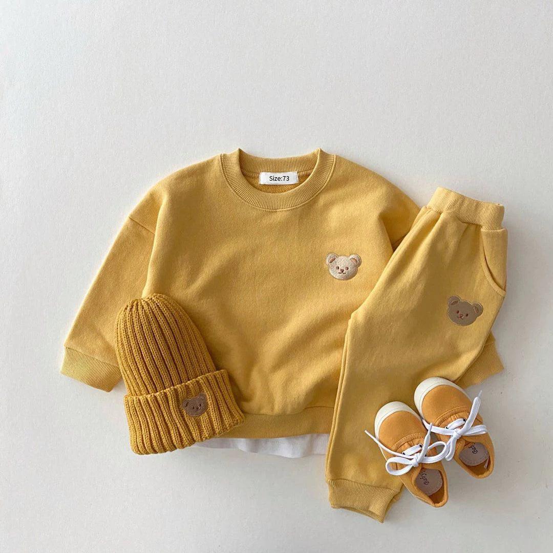 Soft and cozy yellow baby outfit set featuring a sweatshirt and matching pants with adorable embroidered bear face details